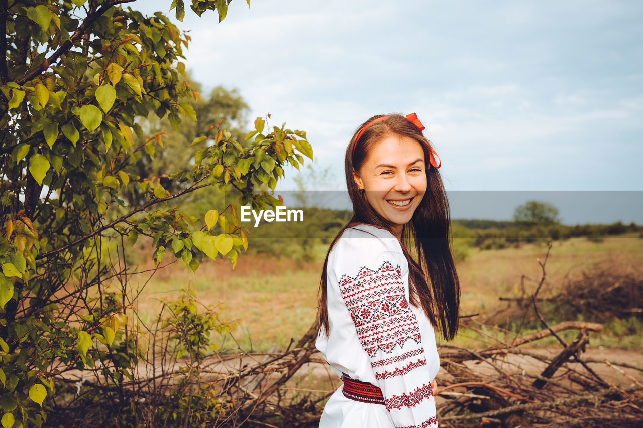 Photo of a smiling young woman in ethnic ukrainian shirt