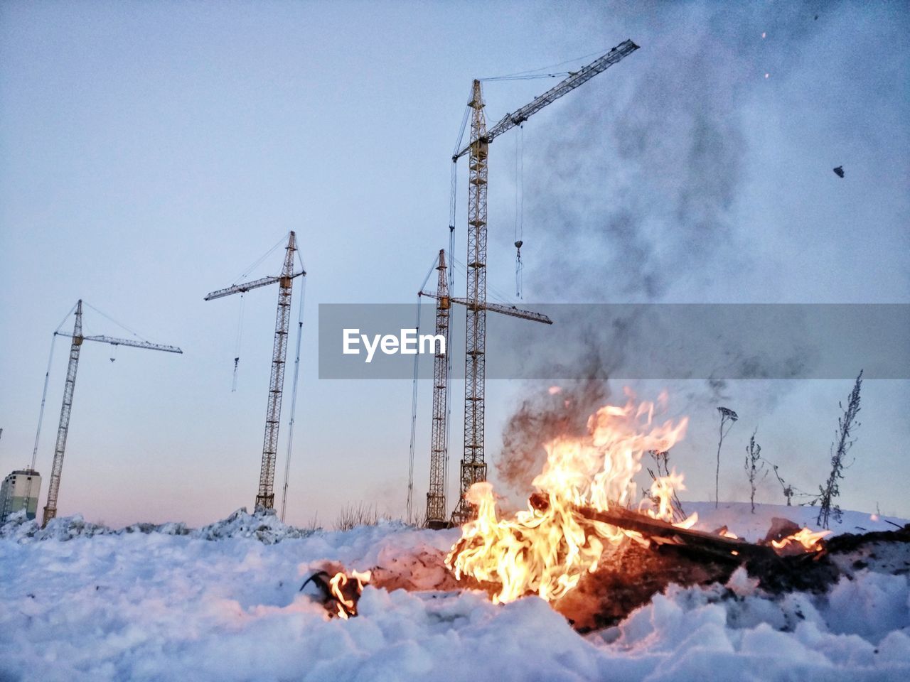 VIEW OF BONFIRE ON SNOW COVERED LAND