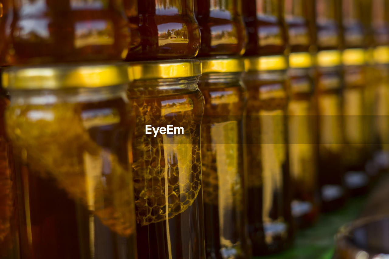 CLOSE-UP OF WINE BOTTLES IN GLASS