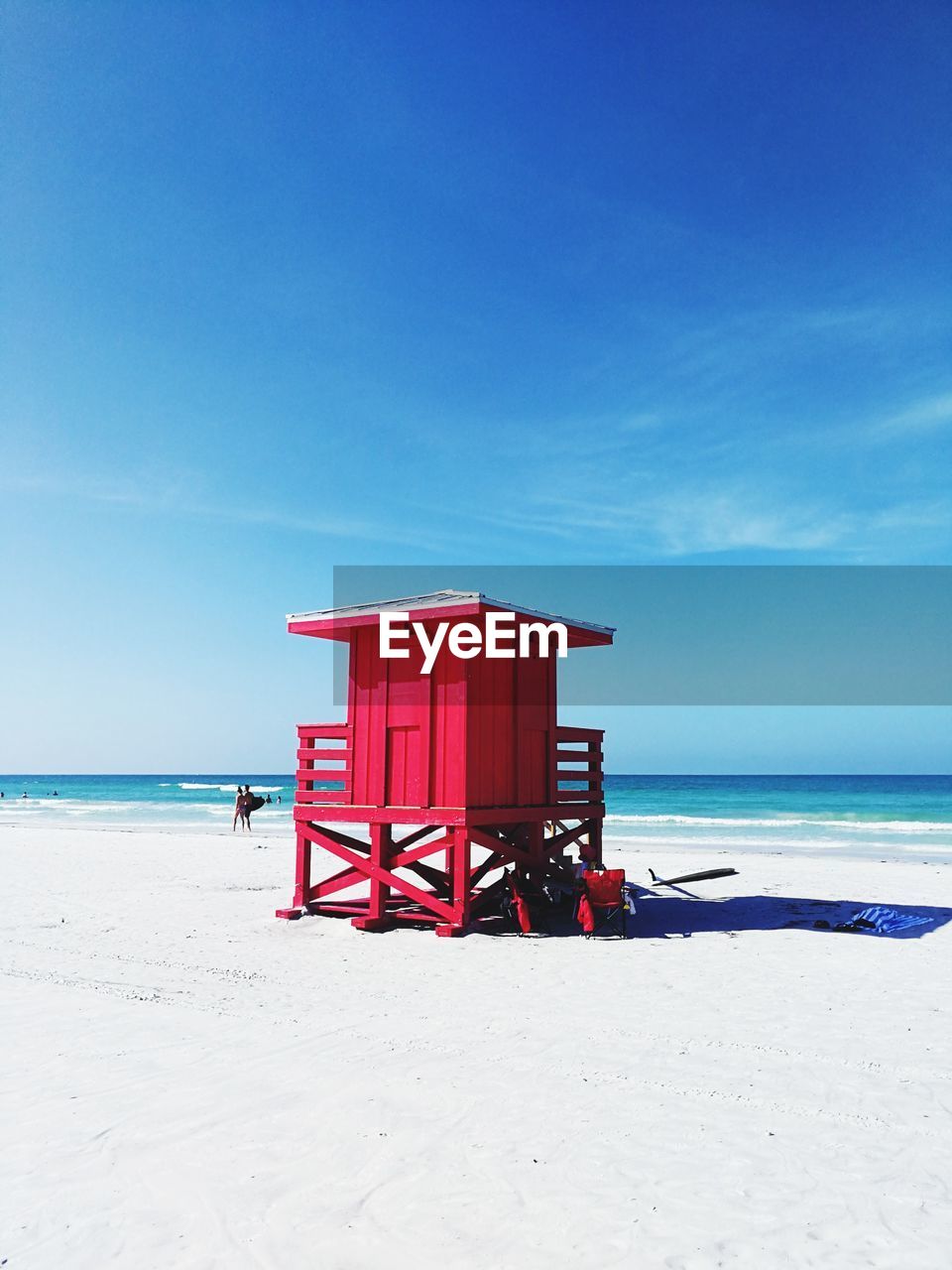 Lifeguard hut on beach against blue sky