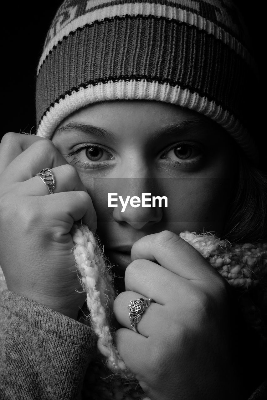 Close-up portrait of young woman in warm clothing