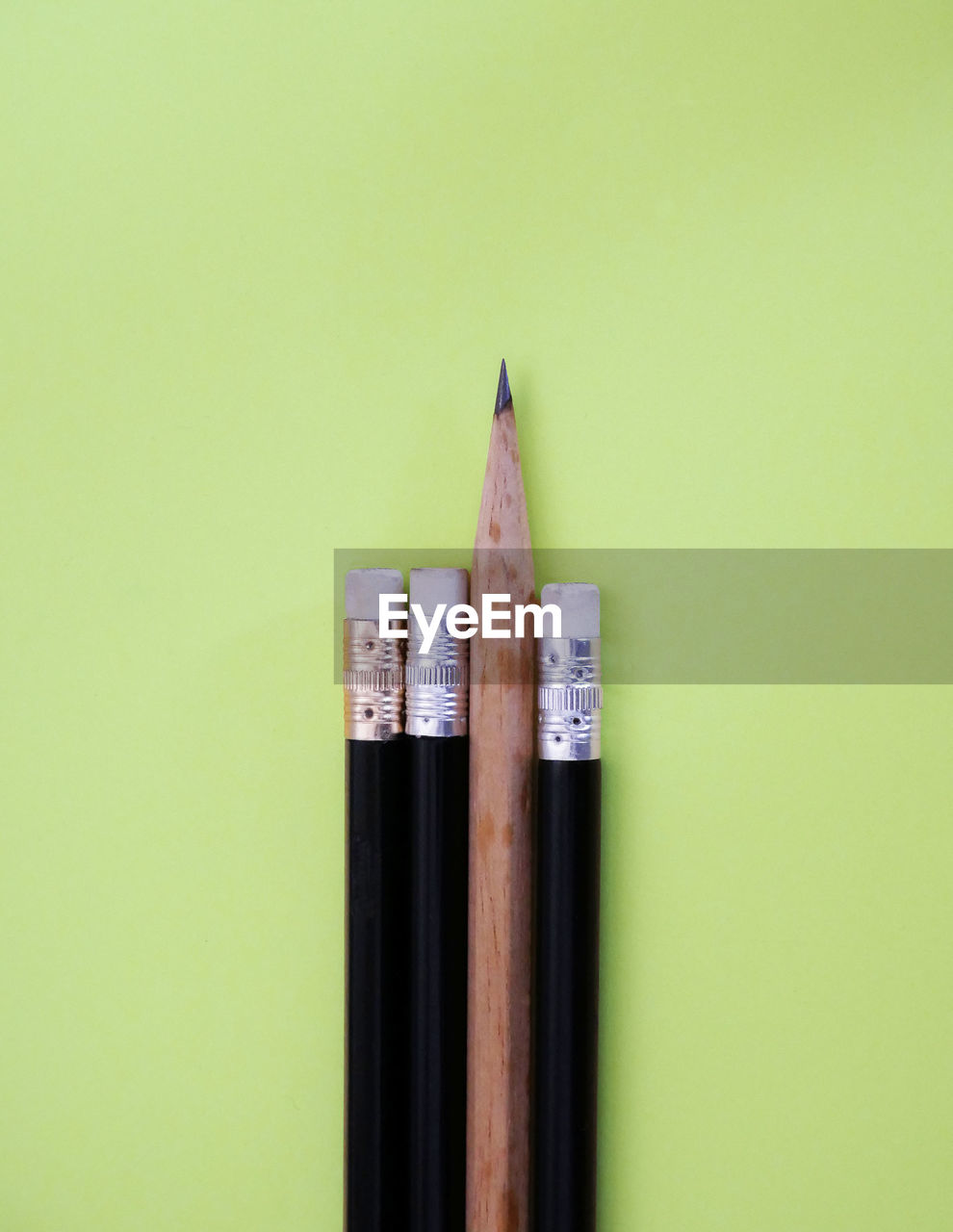 CLOSE-UP OF PENCIL AGAINST WHITE BACKGROUND