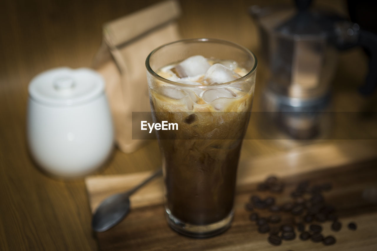 High angle view of iced coffee on cutting board