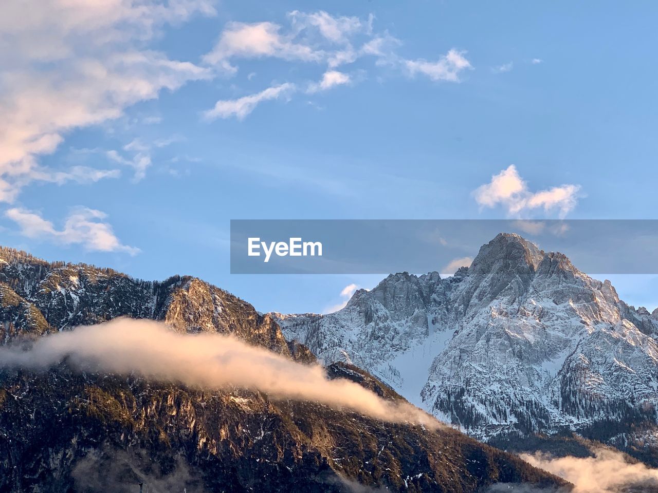 Scenic view of snow covered mountains against sky