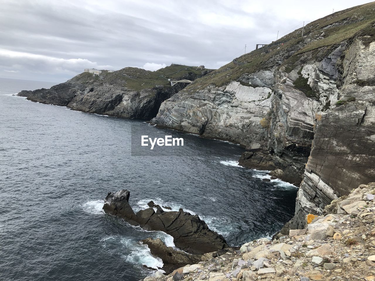 Rock formations by sea against sky