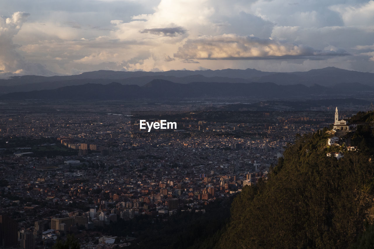 City scape with church in foreground over bogota colombia at sunset