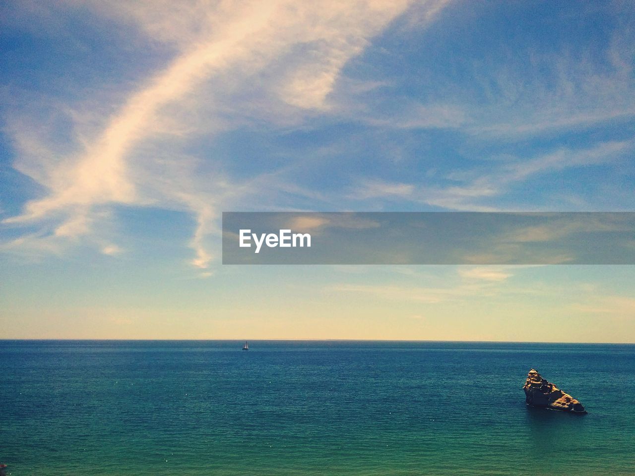 View of seascape against cloudy sky