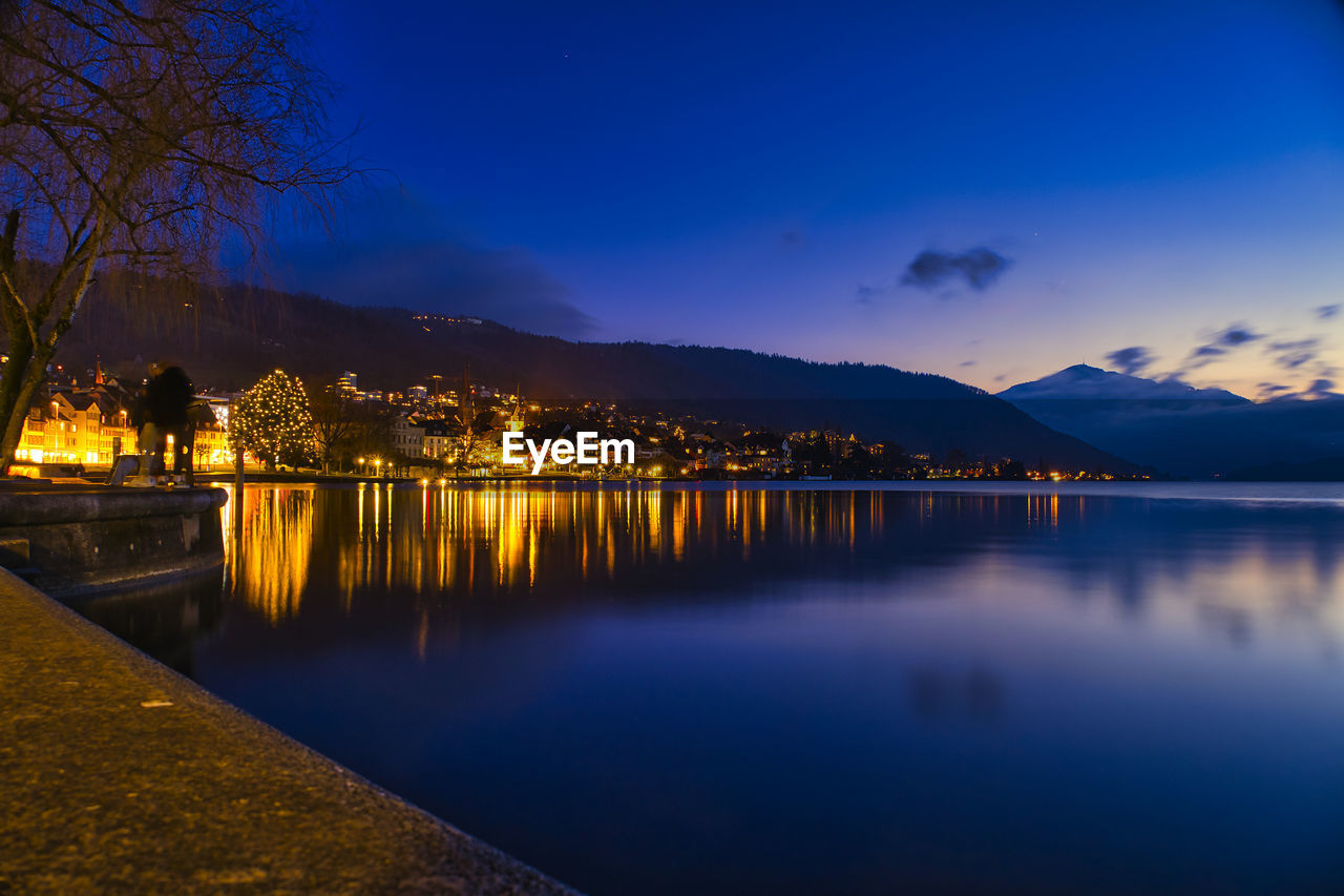 Scenic view of lake against sky at night