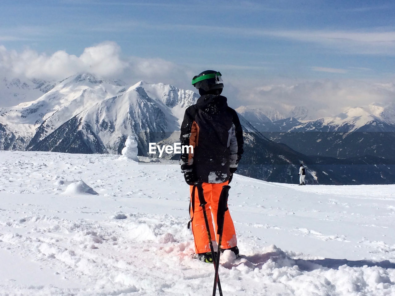 People hiking on snow covered landscape