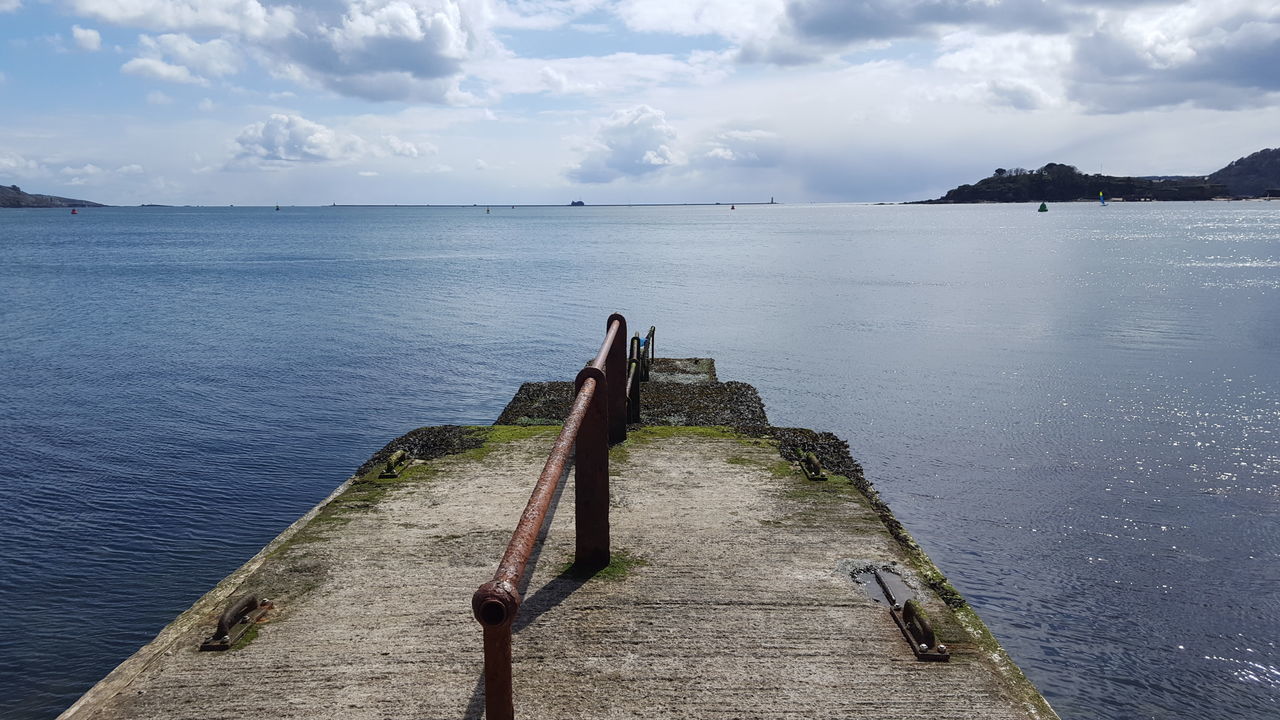 Old jetty over sea against sky