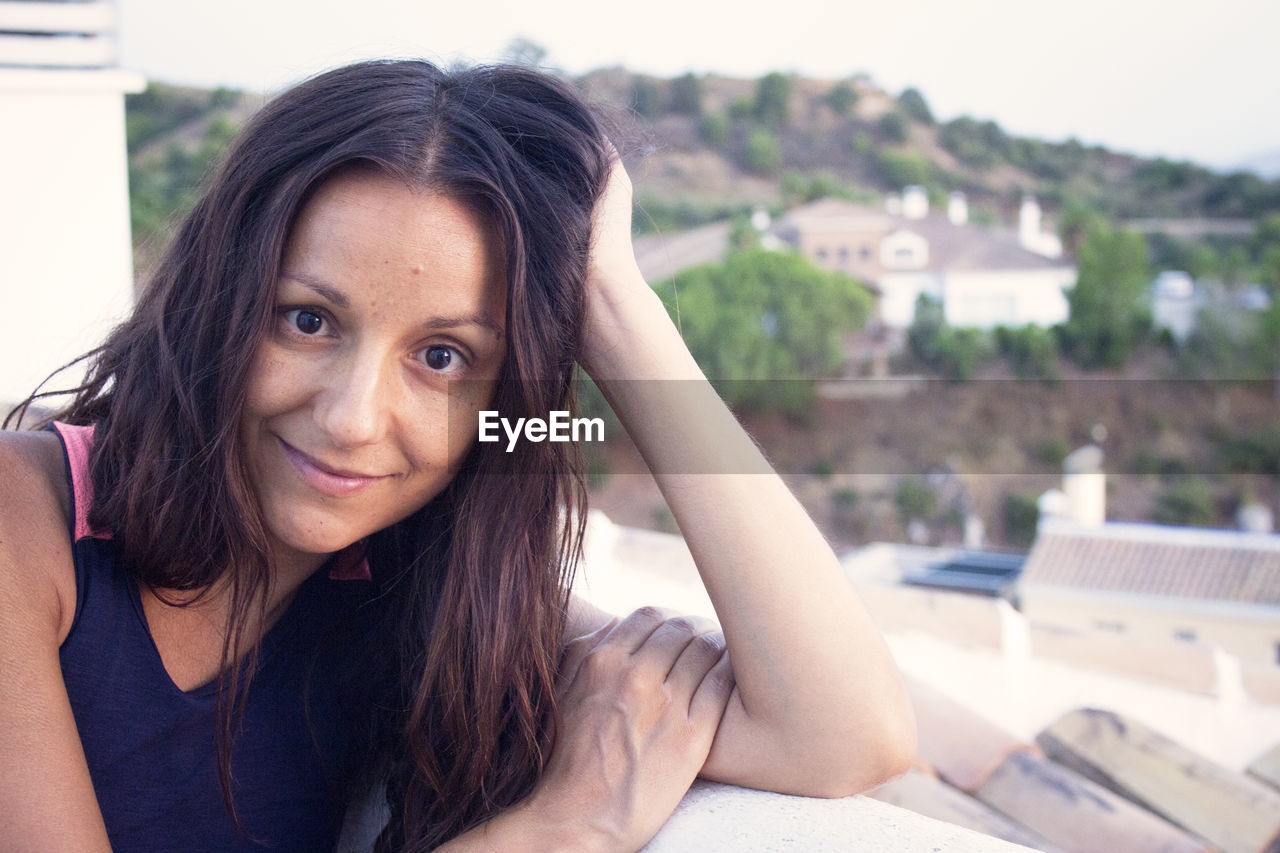 Portrait of youthful woman on mountain background. smiling.