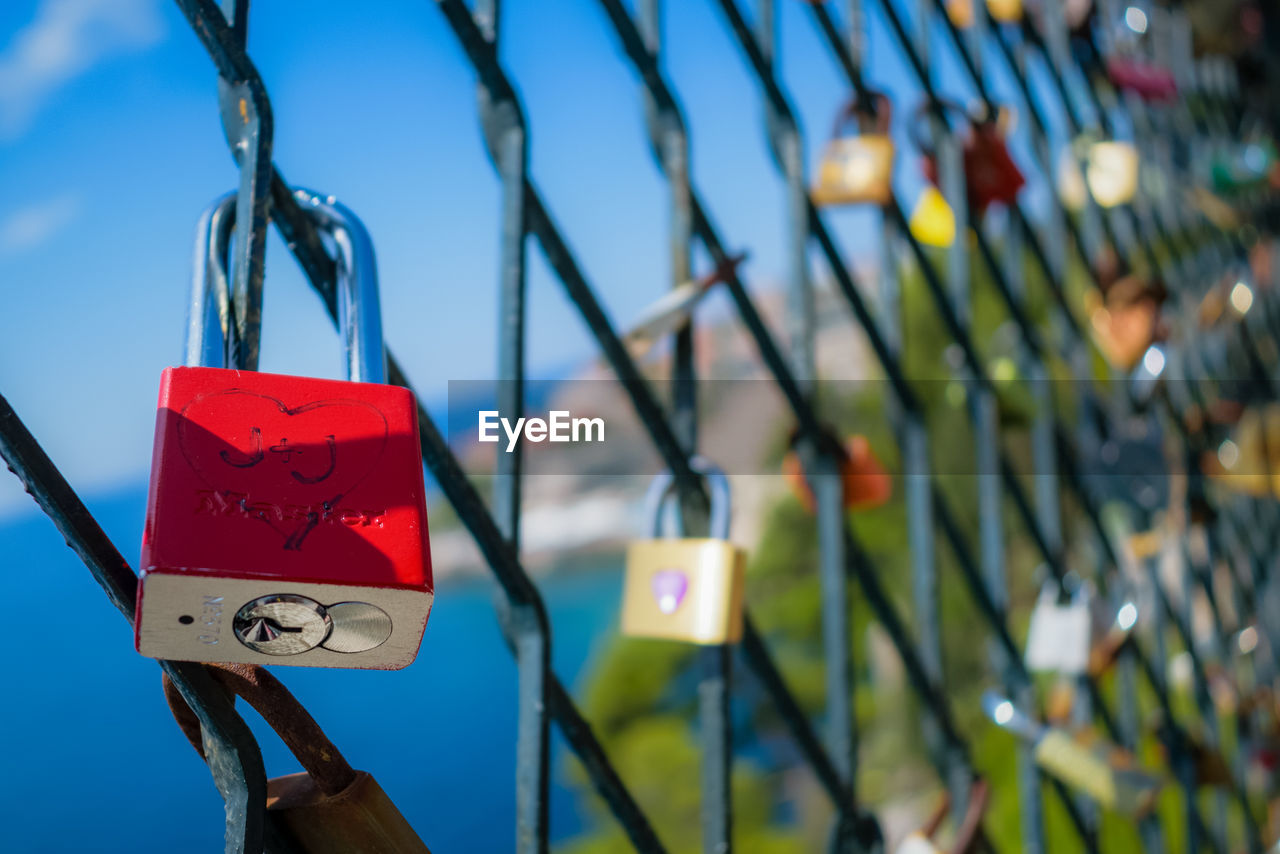 Close-up of padlocks on chainlink fence