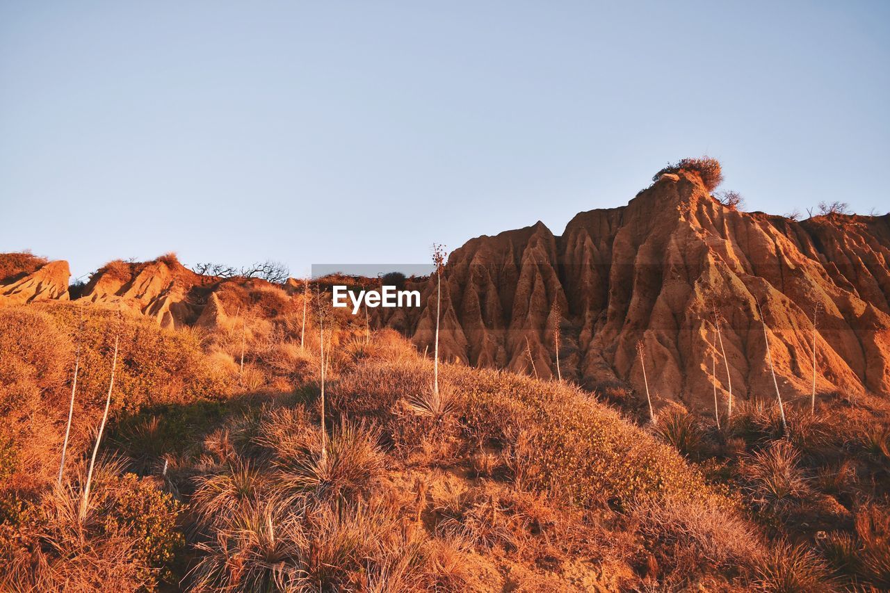 Rock formations on landscape against sky