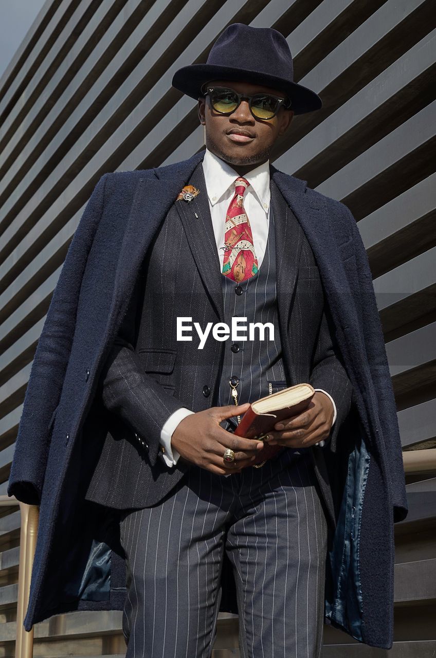 Portrait of young man holding book 