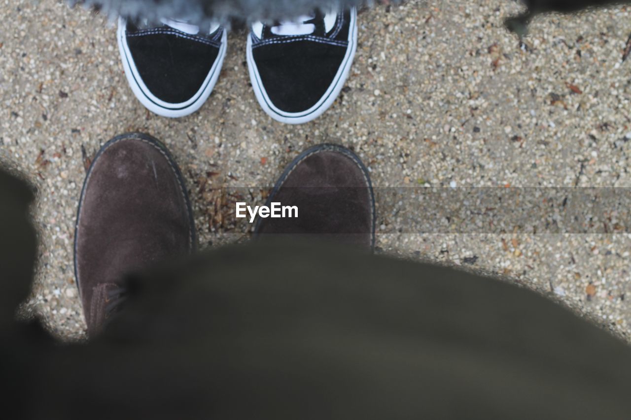 LOW SECTION OF MAN STANDING ON COBBLESTONE