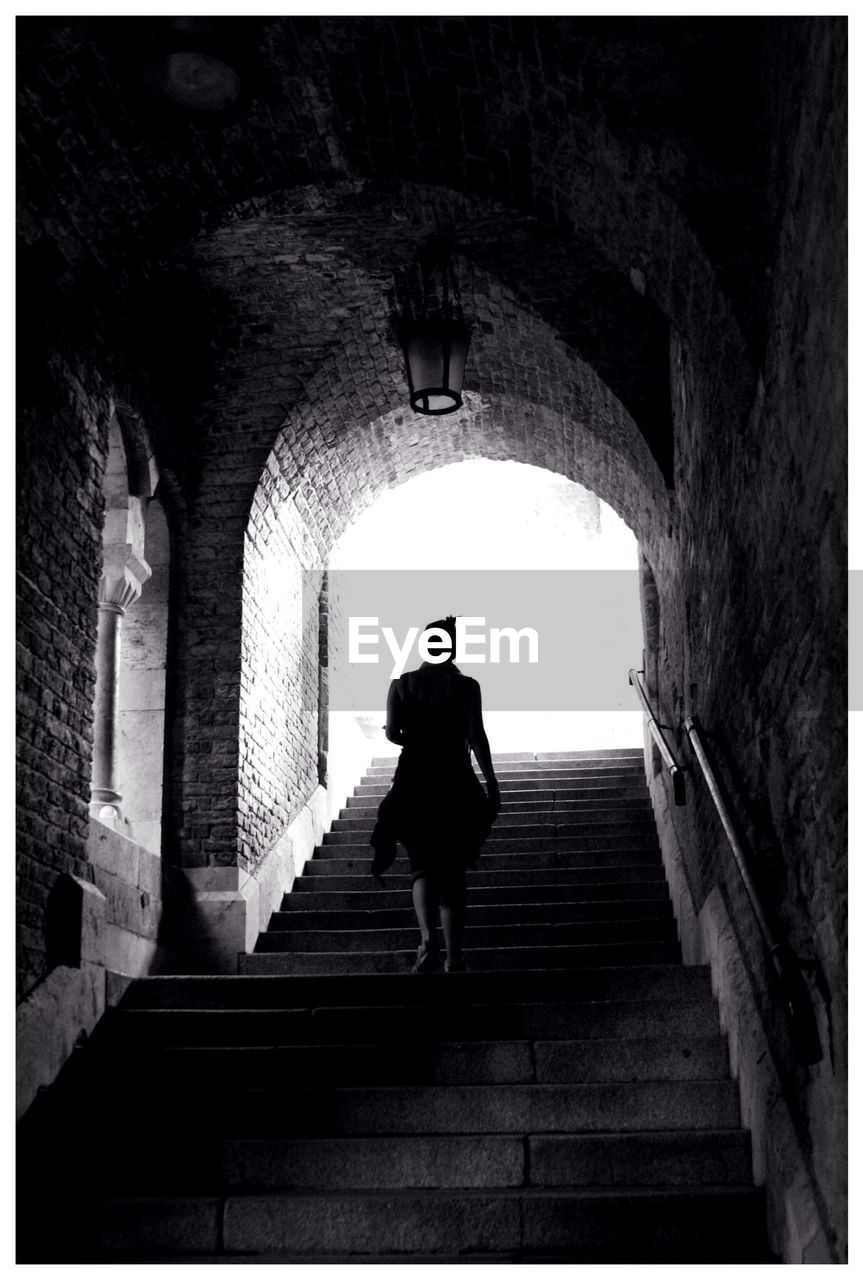 Low angle view of woman walking on steps