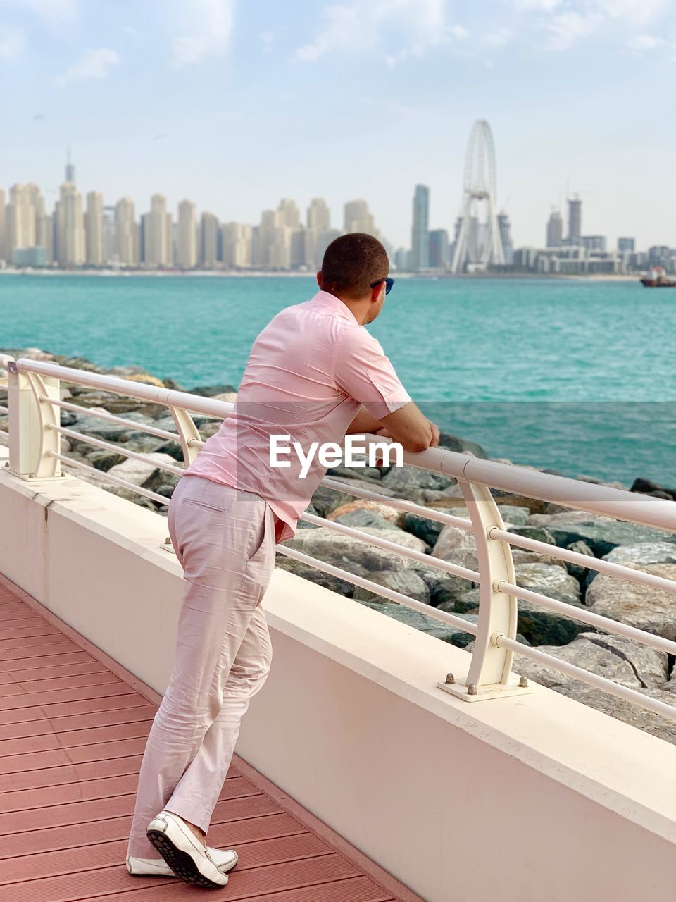 Man looking at river in city