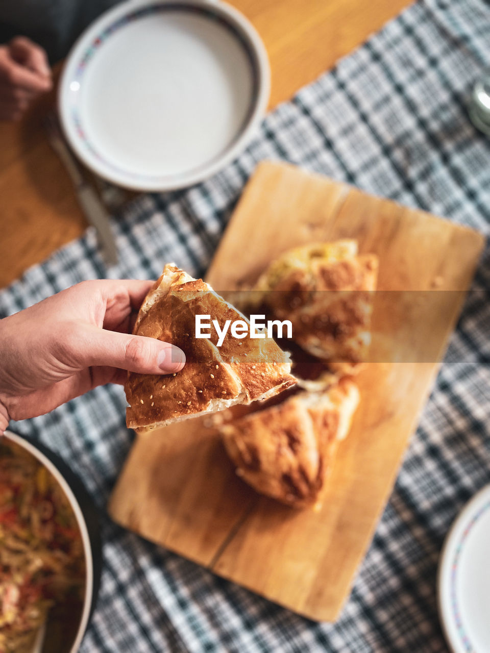 Hand grabbing cheesy bread 