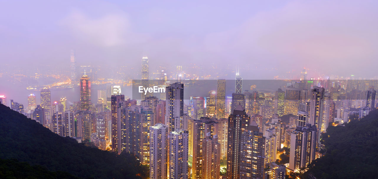 Panoramic view of illuminated victoria harbour against sky