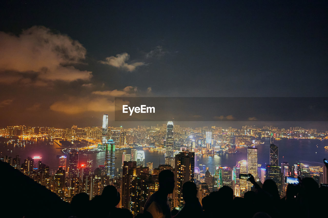 Panoramic view of illuminated city buildings at night