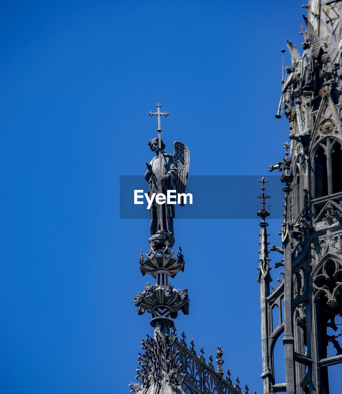 sky, blue, clear sky, architecture, landmark, spire, built structure, low angle view, nature, no people, day, statue, sunny, sculpture, religion, outdoors, building exterior, travel destinations, tower, metal, belief, copy space, representation