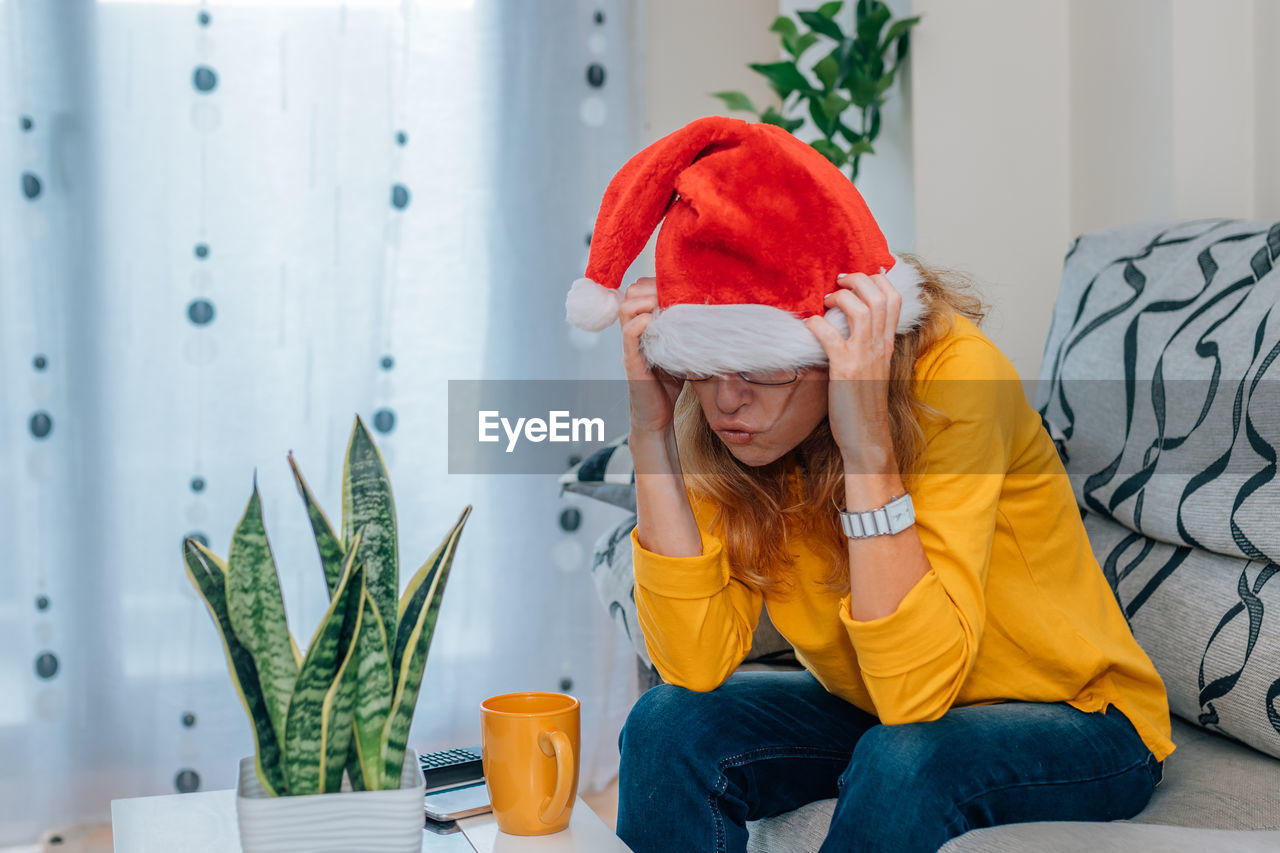 Stressed woman with santa claus hat at christmas