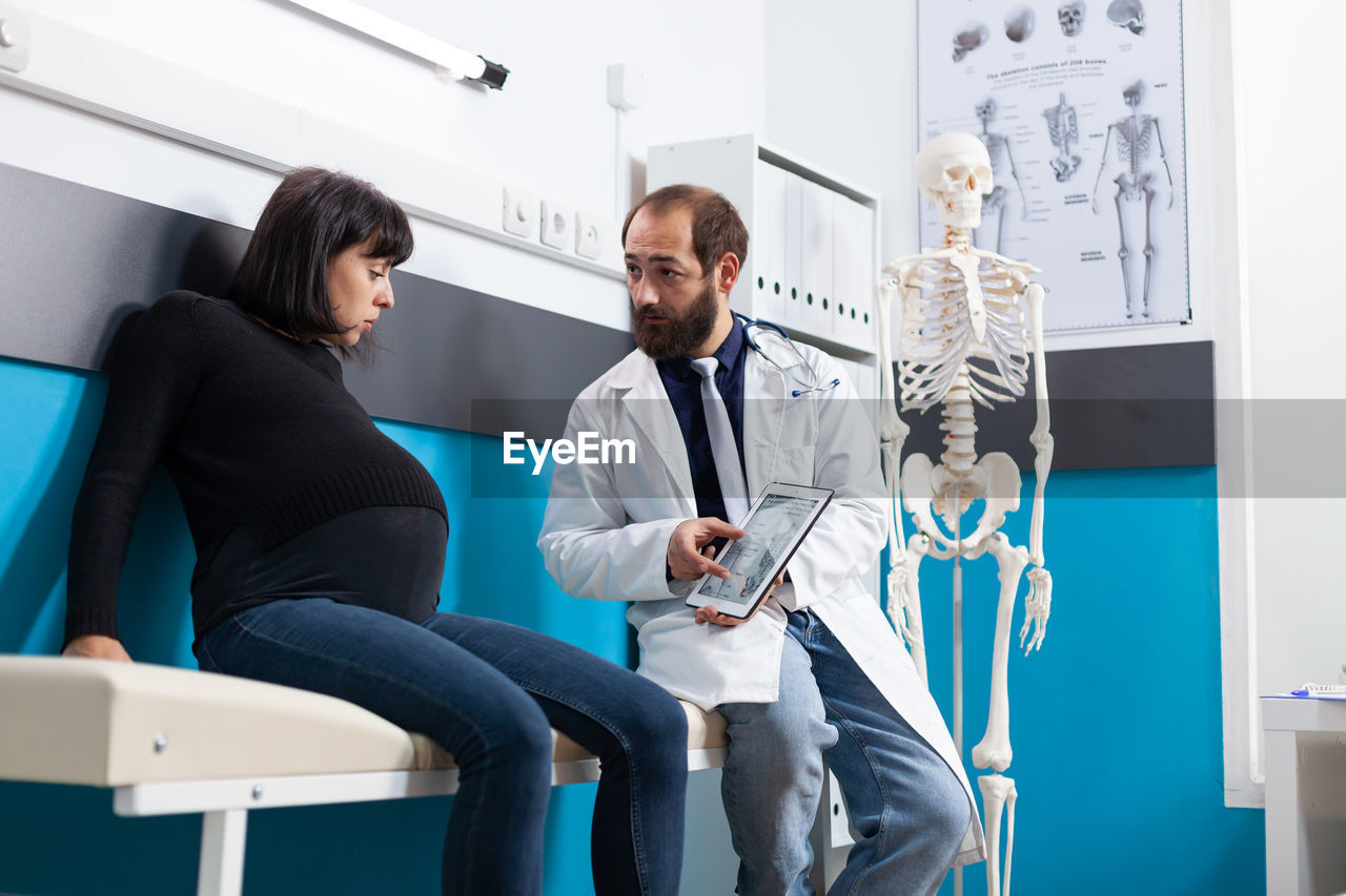 Doctor examining patient in clinic