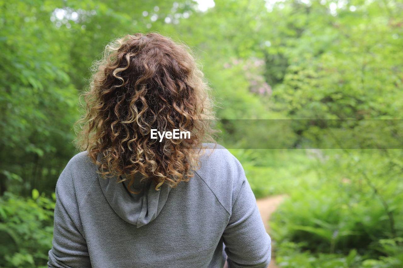 Rear view of woman against trees