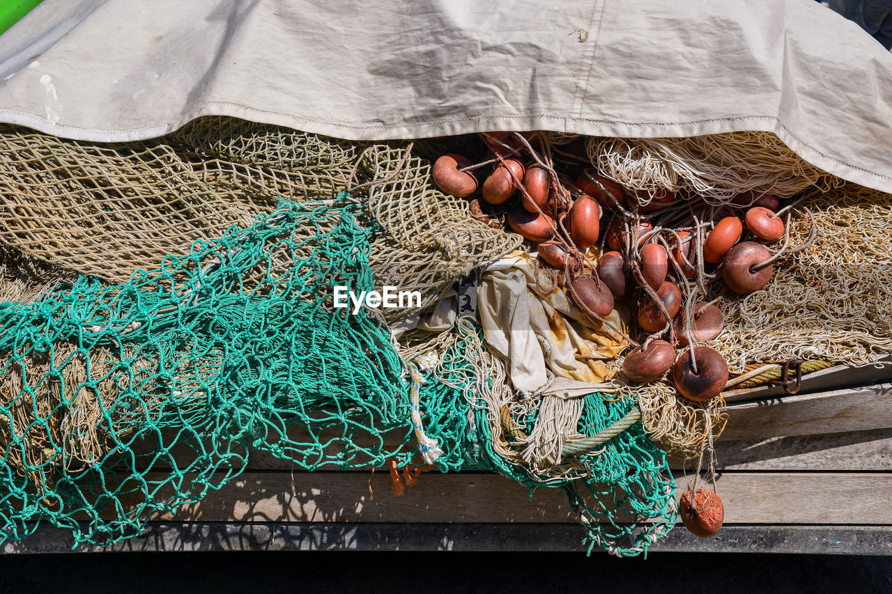 Close-up of fishing nets on a wooden platform of the harbor, liguria, italy