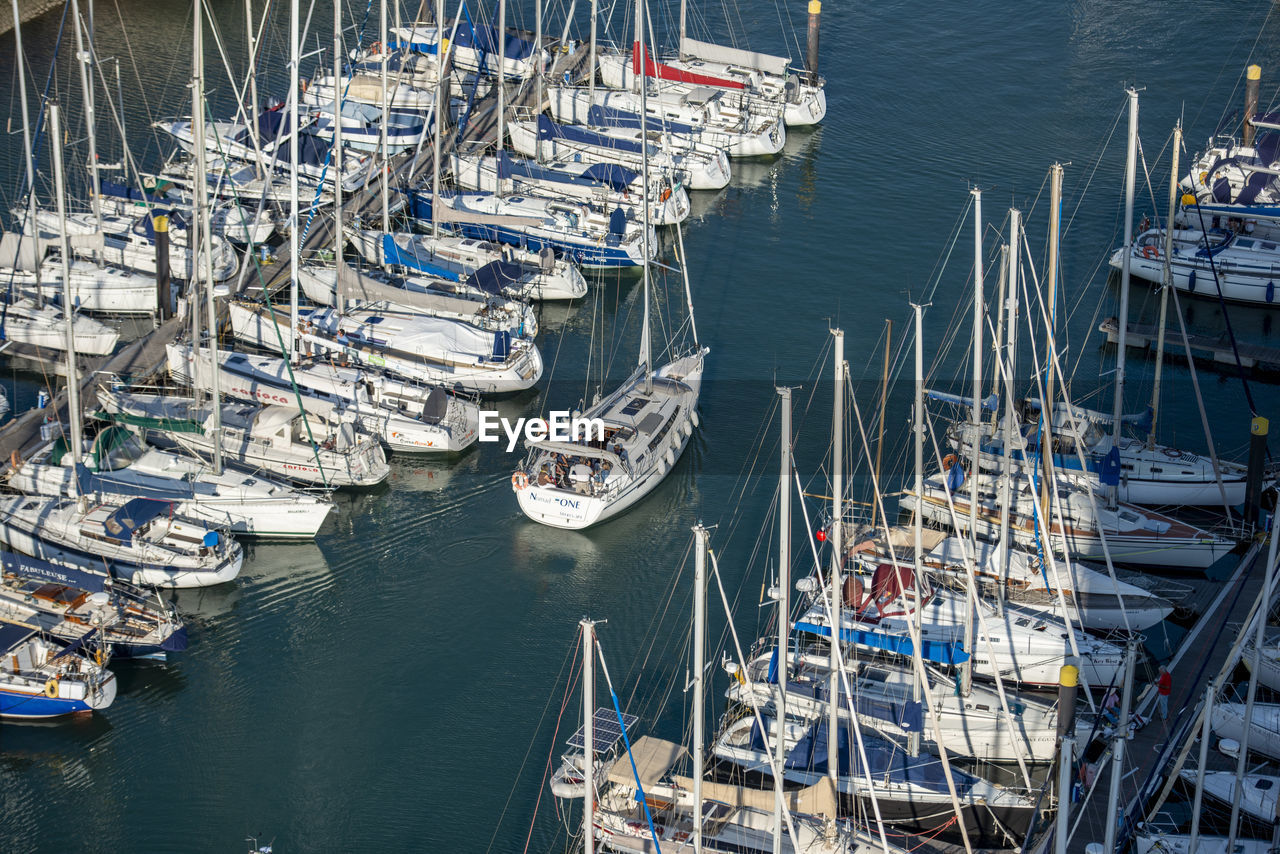 nautical vessel, water, transportation, mode of transportation, marina, dock, moored, harbor, port, sea, sailboat, ship, no people, vehicle, high angle view, pole, pier, boat, infrastructure, mast, nature, day, architecture, travel, watercraft, outdoors, travel destinations, in a row, large group of objects