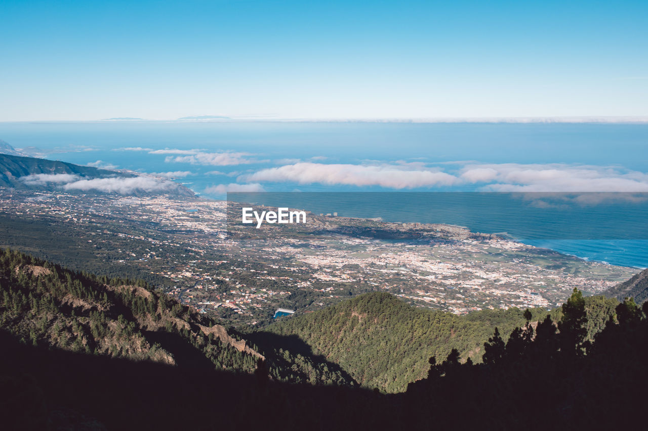 High angle view of sea and cityscape against sky