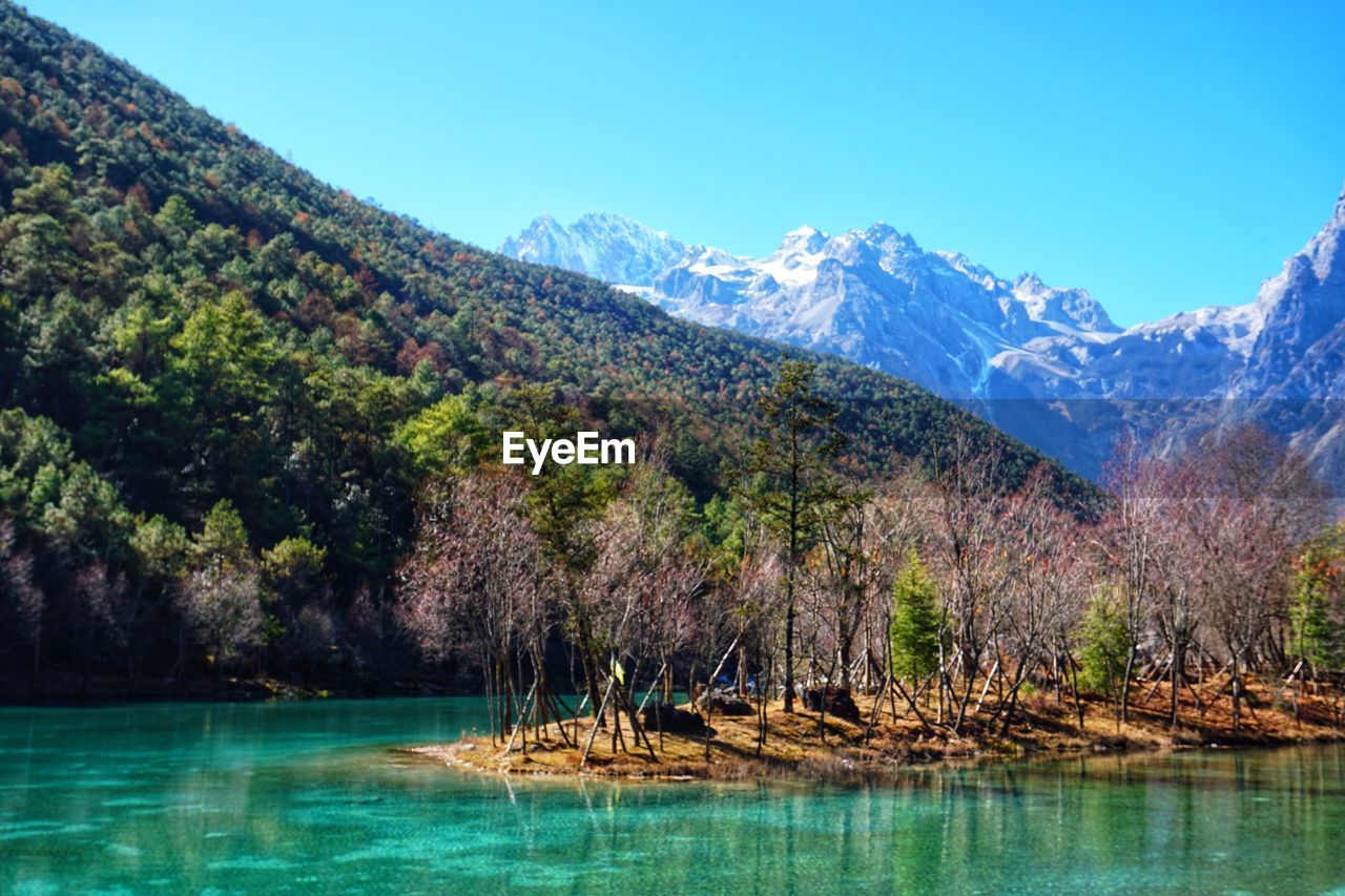 Scenic view of lake and mountains against sky