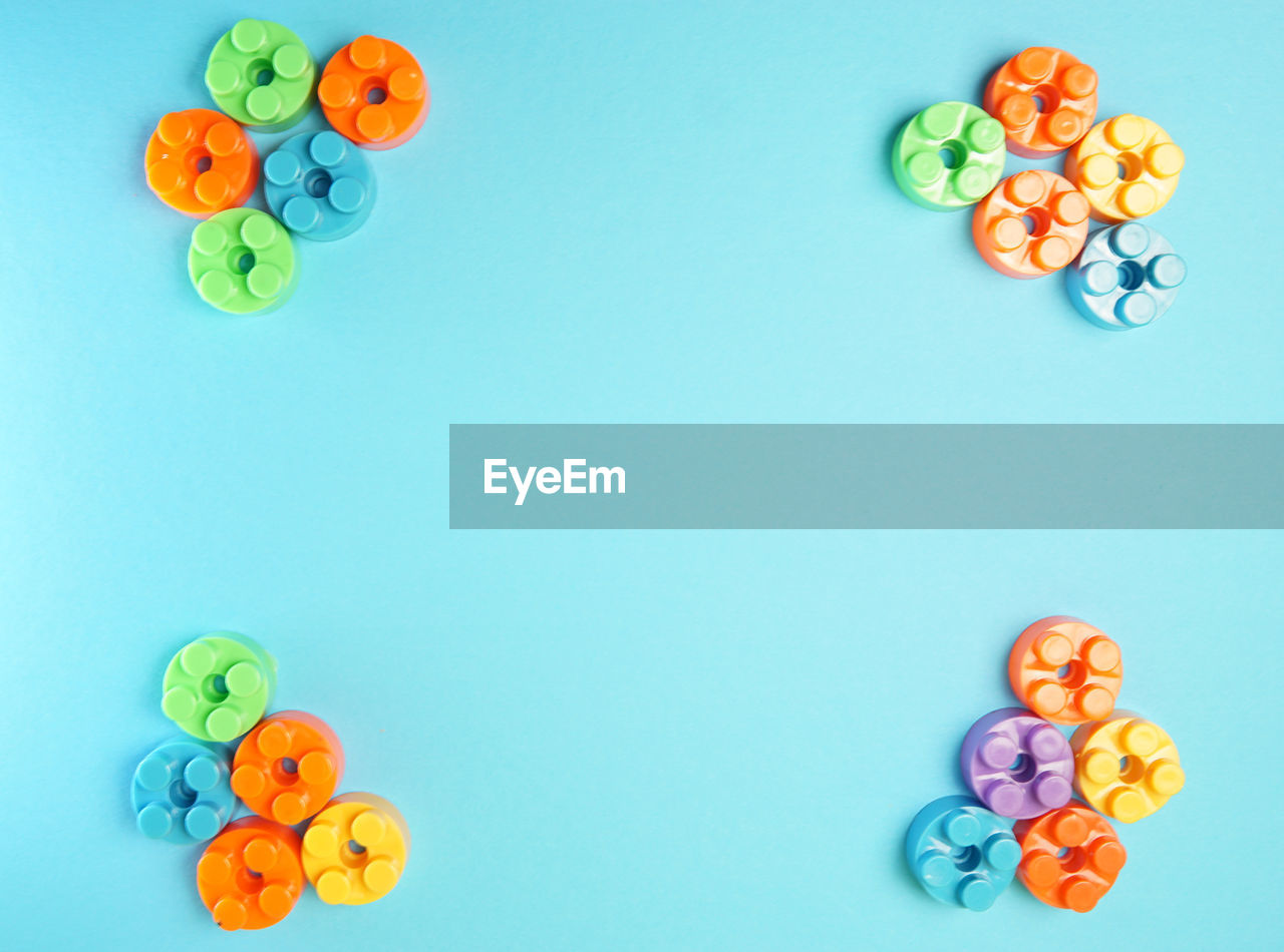 HIGH ANGLE VIEW OF CANDIES ON BLUE BACKGROUND