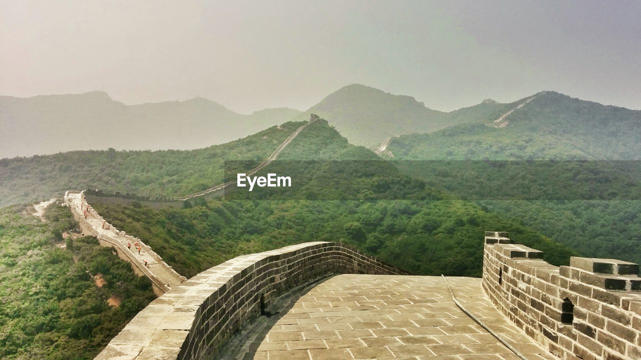 STEPS LEADING TOWARDS MOUNTAINS AGAINST CLEAR SKY