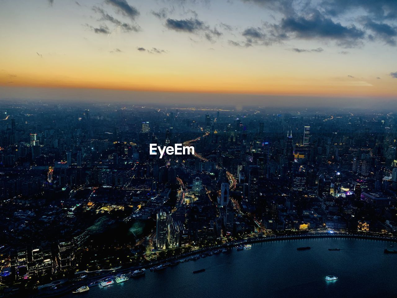 AERIAL VIEW OF ILLUMINATED BUILDINGS AT NIGHT