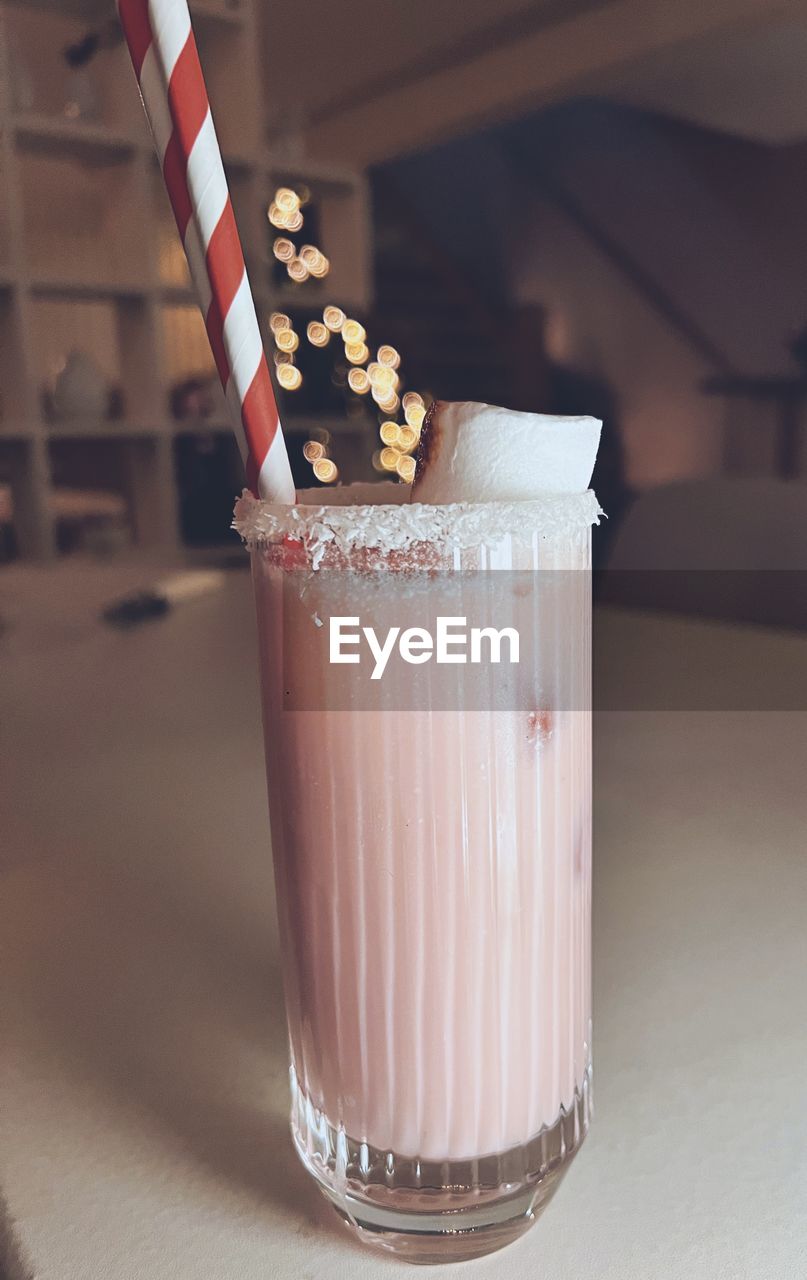 milkshake, soft drink, food and drink, drink, food, refreshment, dessert, indoors, household equipment, glass, drinking glass, dairy, milk, lighting, straw, no people, sweet food, drinking straw, alcoholic beverage, healthy eating, table, freshness, sweet