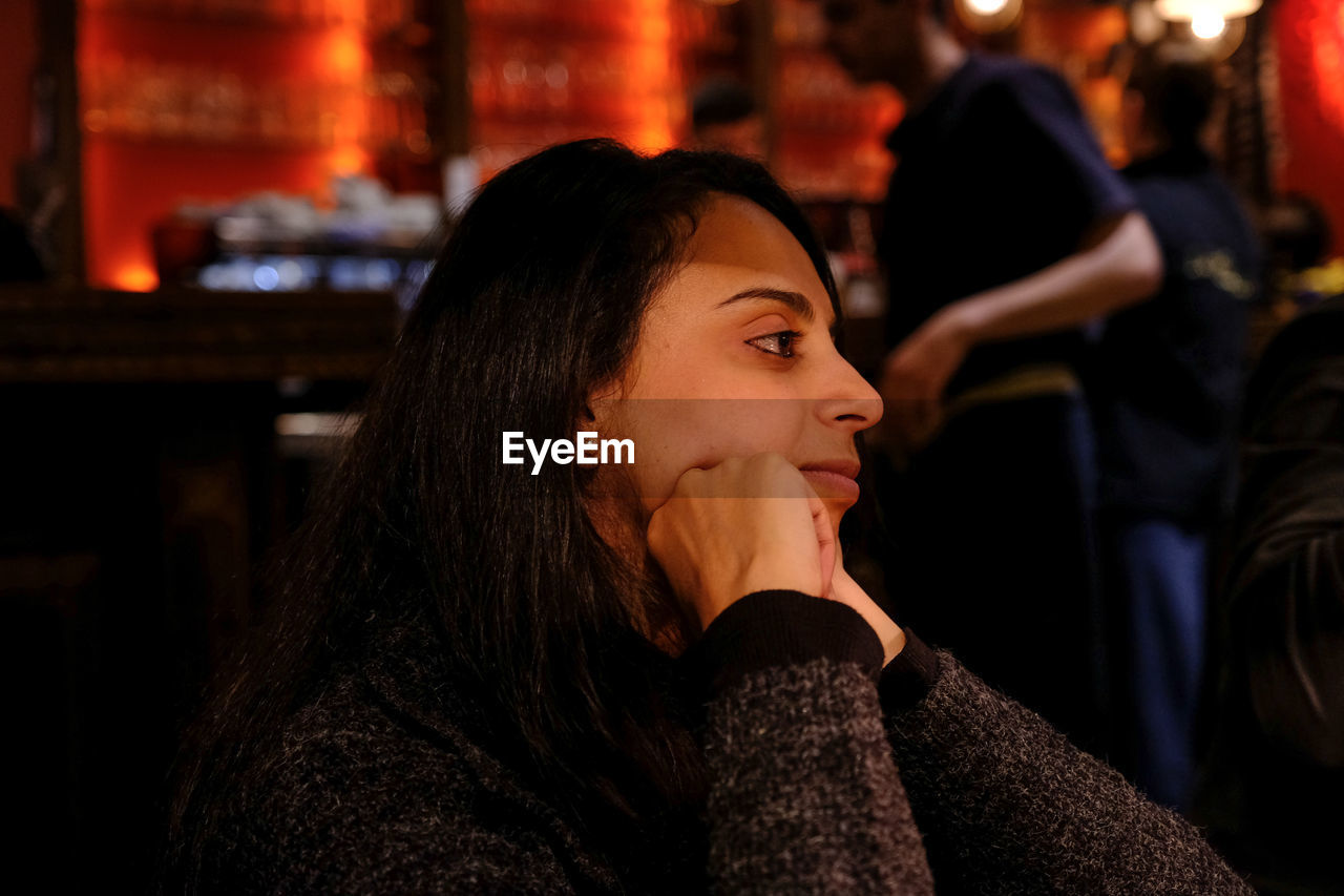 Thoughtful woman sitting in restaurant