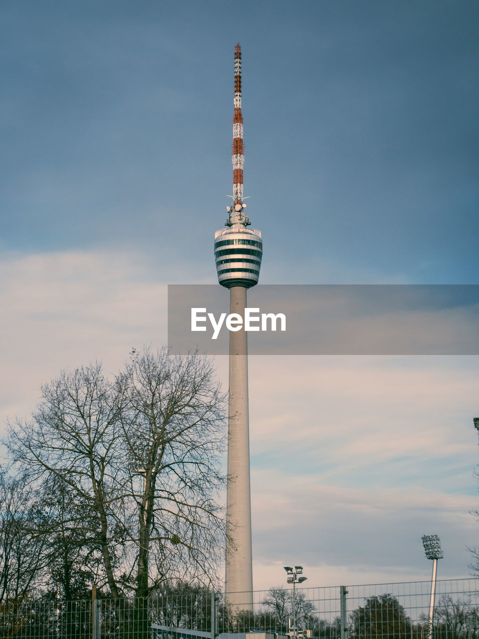 Low angle view of stuttgart tv tower against blue, cloudy sky