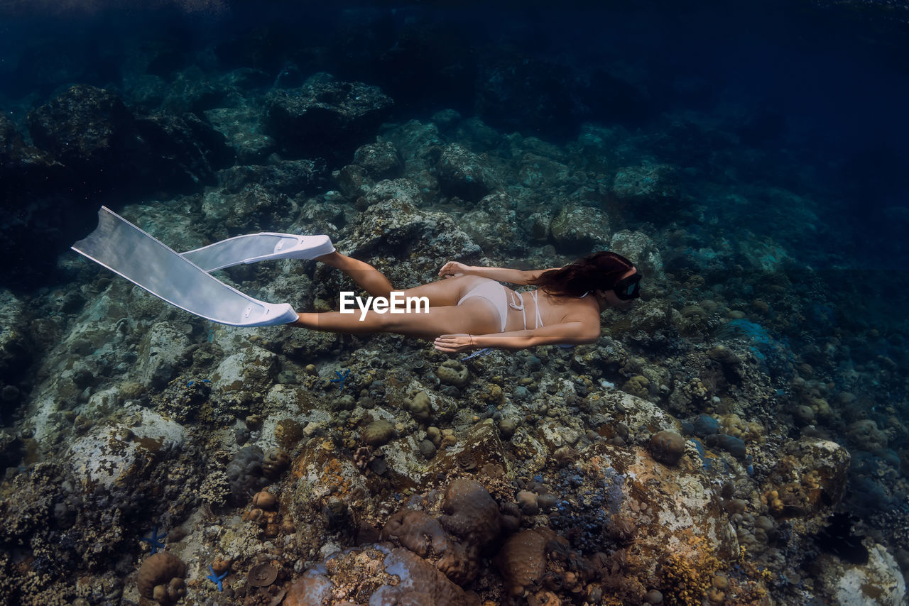 high angle view of woman swimming in sea