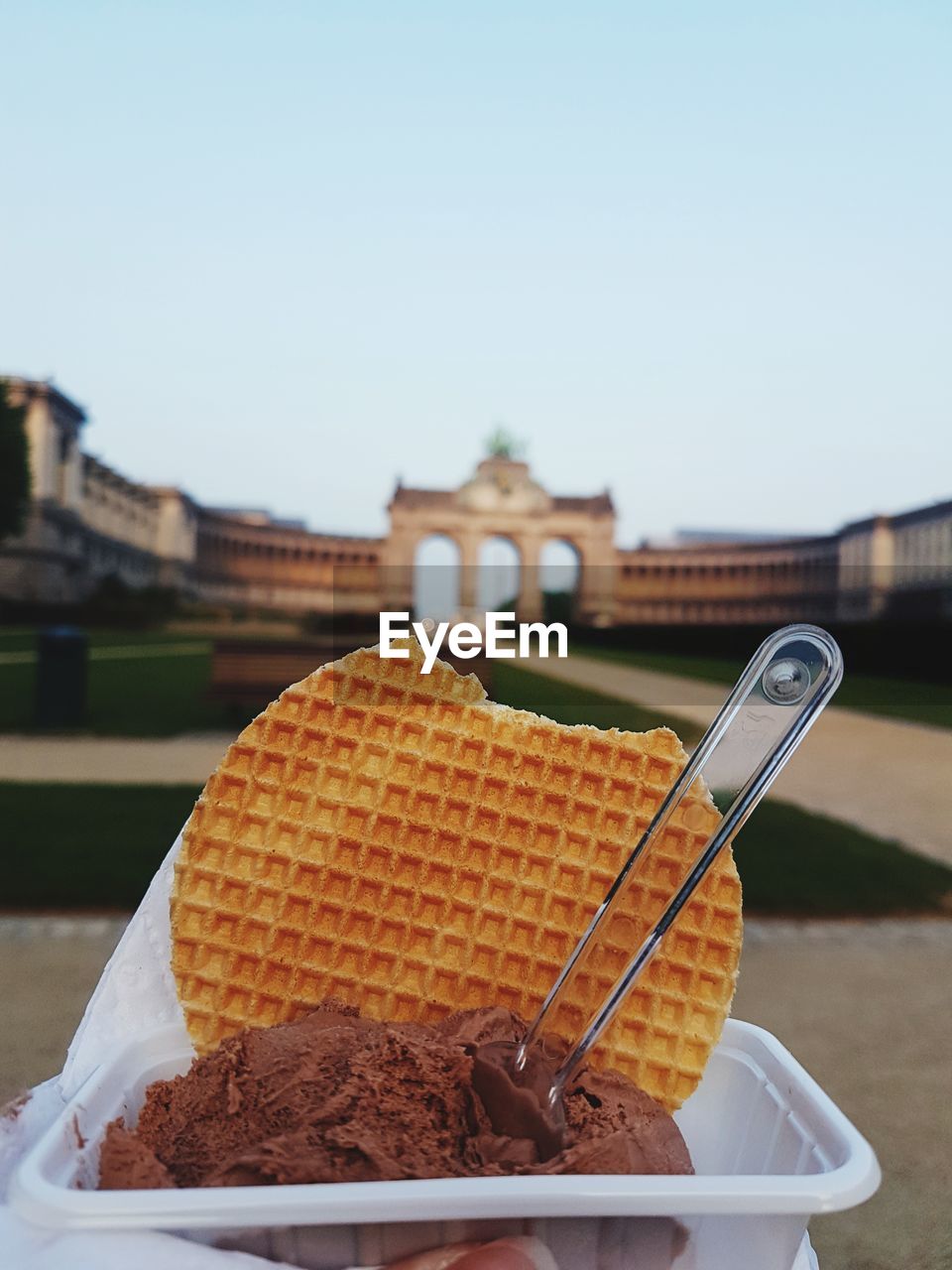 Close-up of fresh dessert at historic building against clear sky