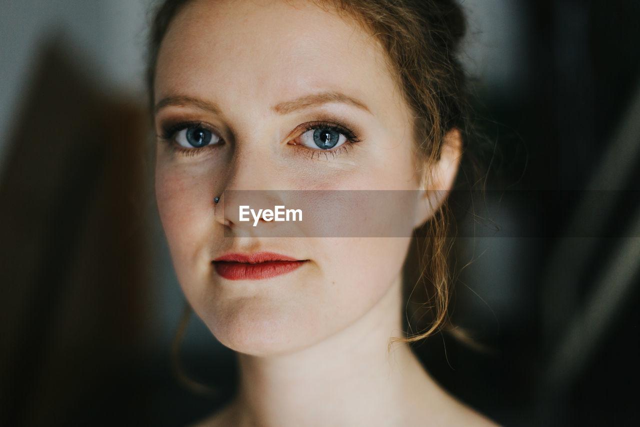 Portrait of smiling young woman at cafe