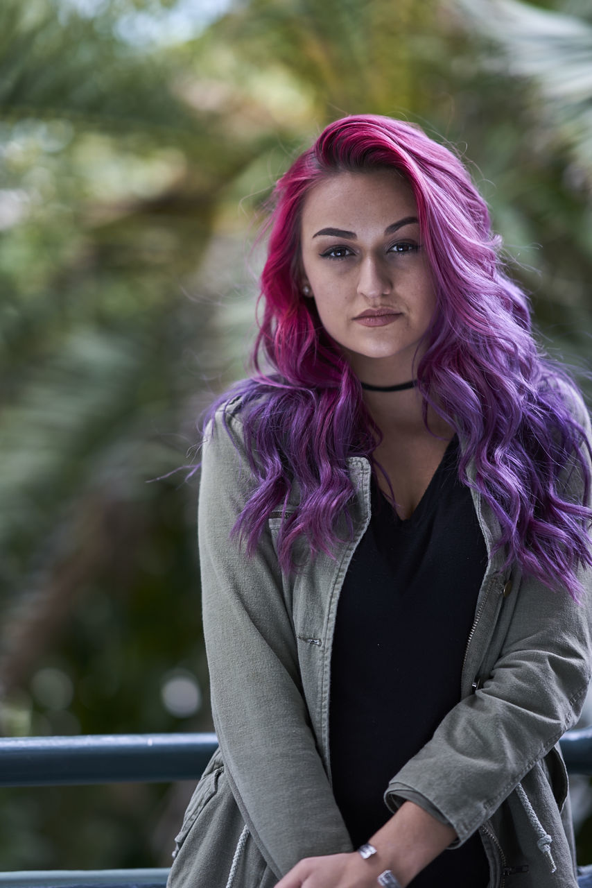 PORTRAIT OF A YOUNG WOMAN WITH PINK HAIR