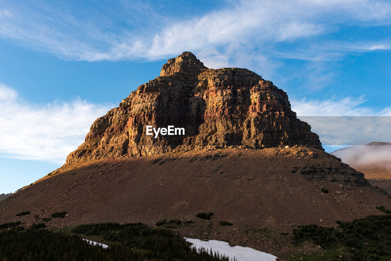 LOW ANGLE VIEW OF ROCK FORMATIONS ON MOUNTAIN AGAINST SKY