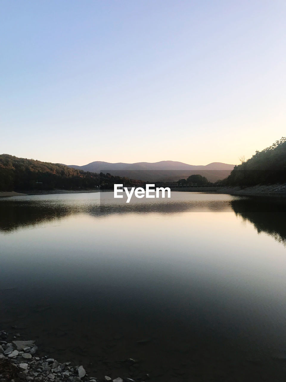 SCENIC VIEW OF LAKE AGAINST SKY DURING SUNSET