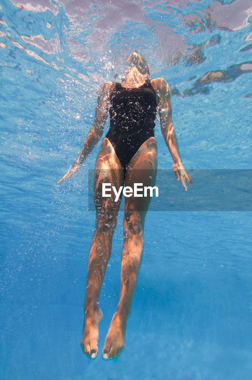 Mid adult woman swimming in pool