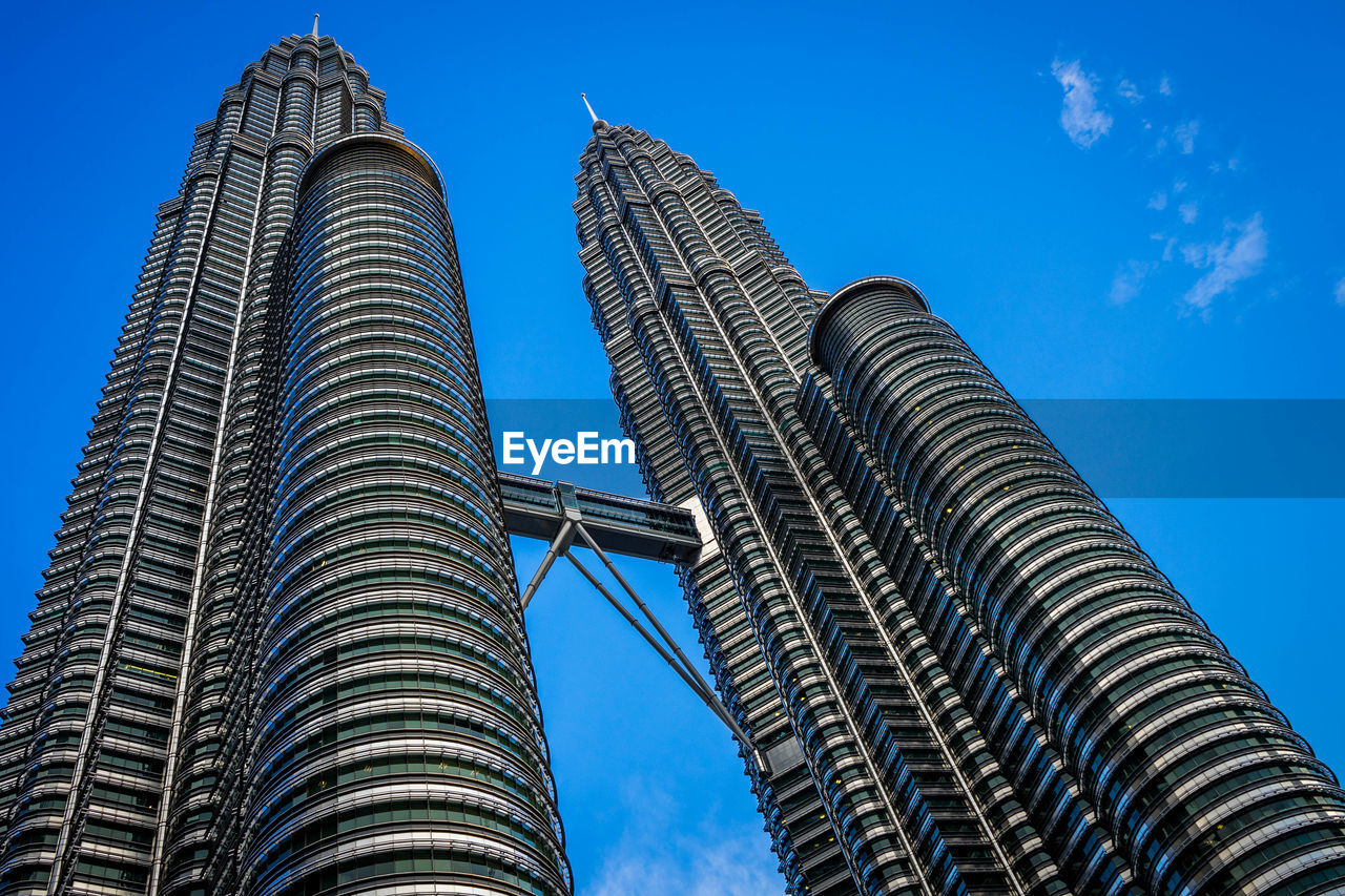 LOW ANGLE VIEW OF OFFICE BUILDING AGAINST BLUE SKY