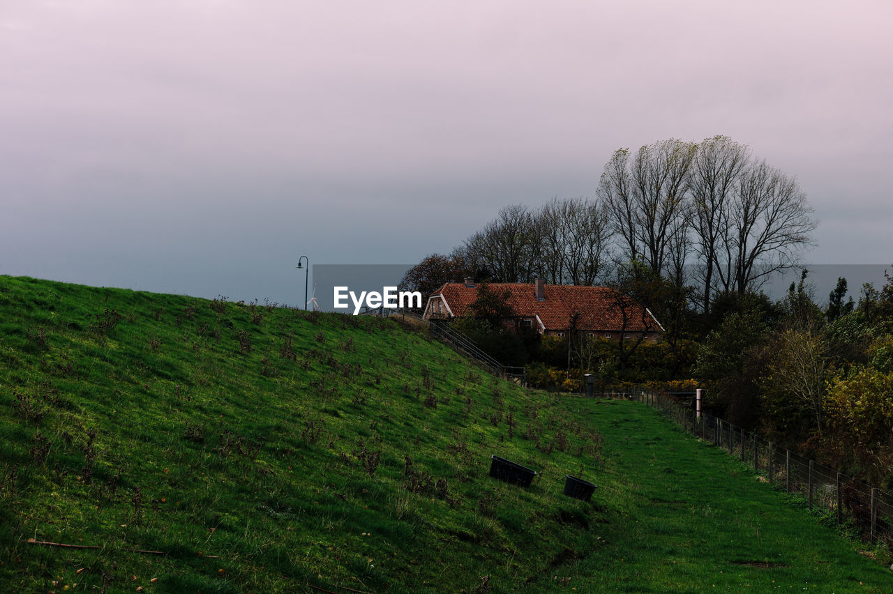 House on field against sky