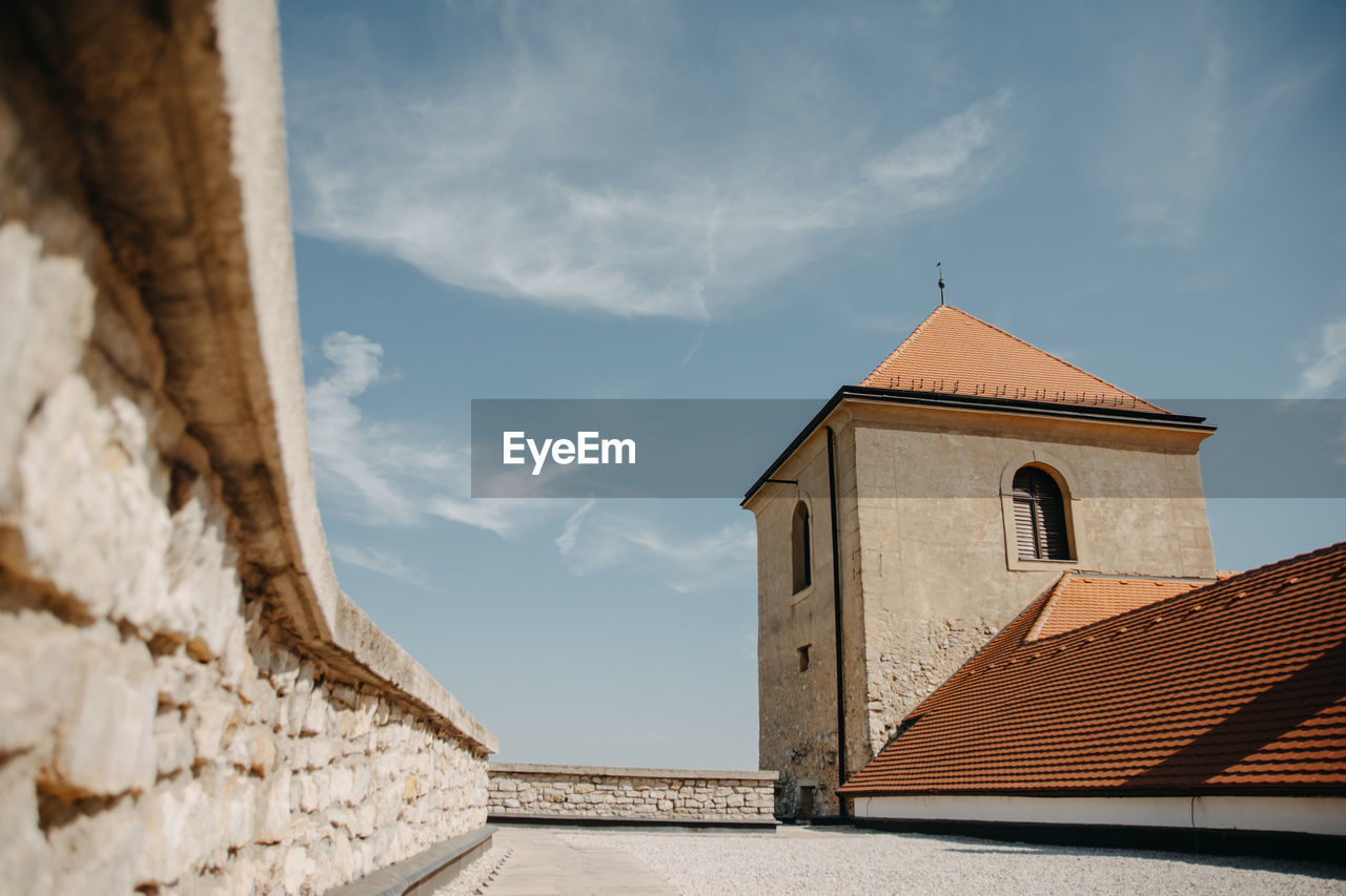 architecture, built structure, building exterior, sky, building, place of worship, cloud, religion, nature, belief, no people, history, travel destinations, spirituality, the past, day, wall - building feature, wall, tower, outdoors, blue, house, sunlight, travel, roof, old, tourism
