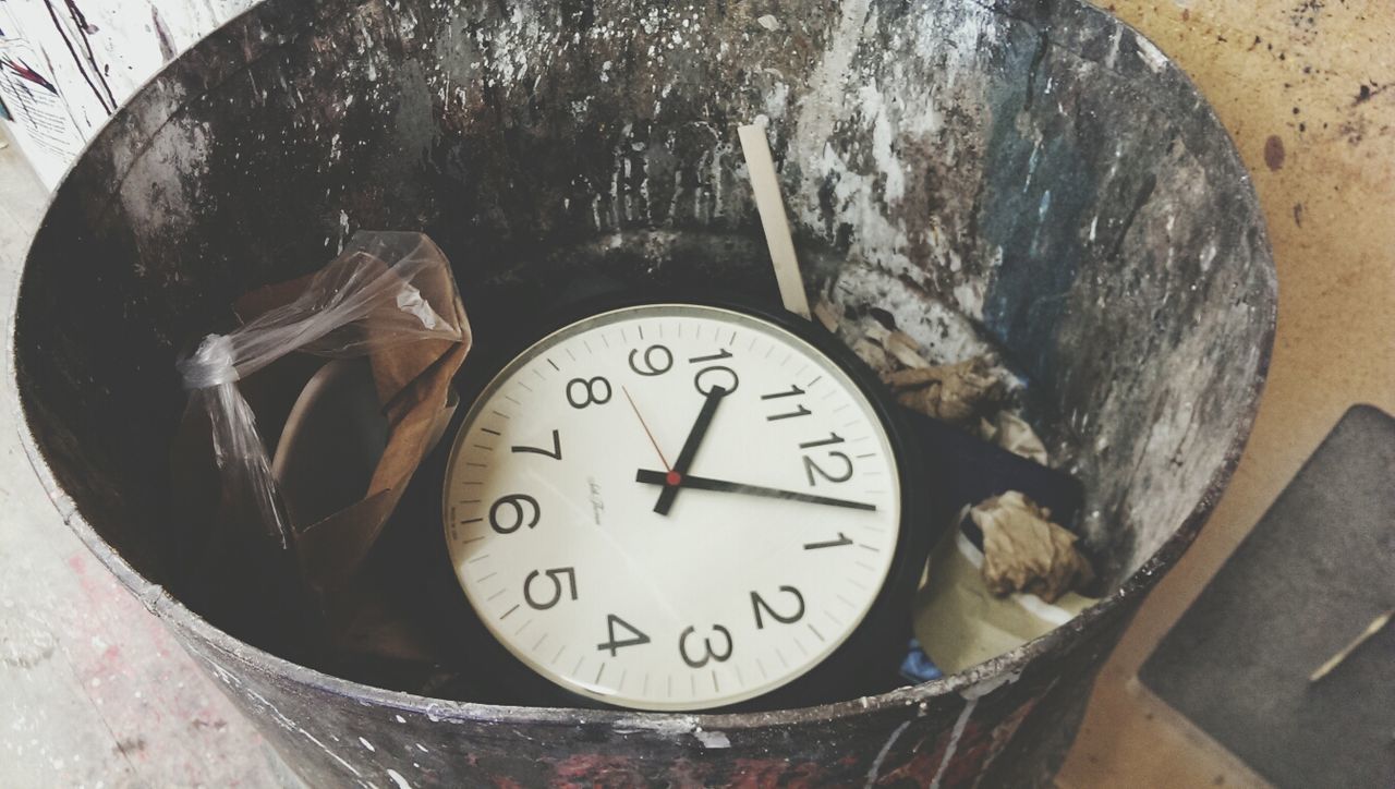 Close-up of watch in rusty bucket