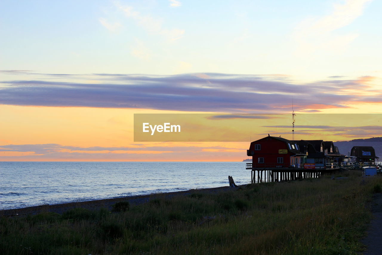 SCENIC VIEW OF BEACH AGAINST SKY DURING SUNSET